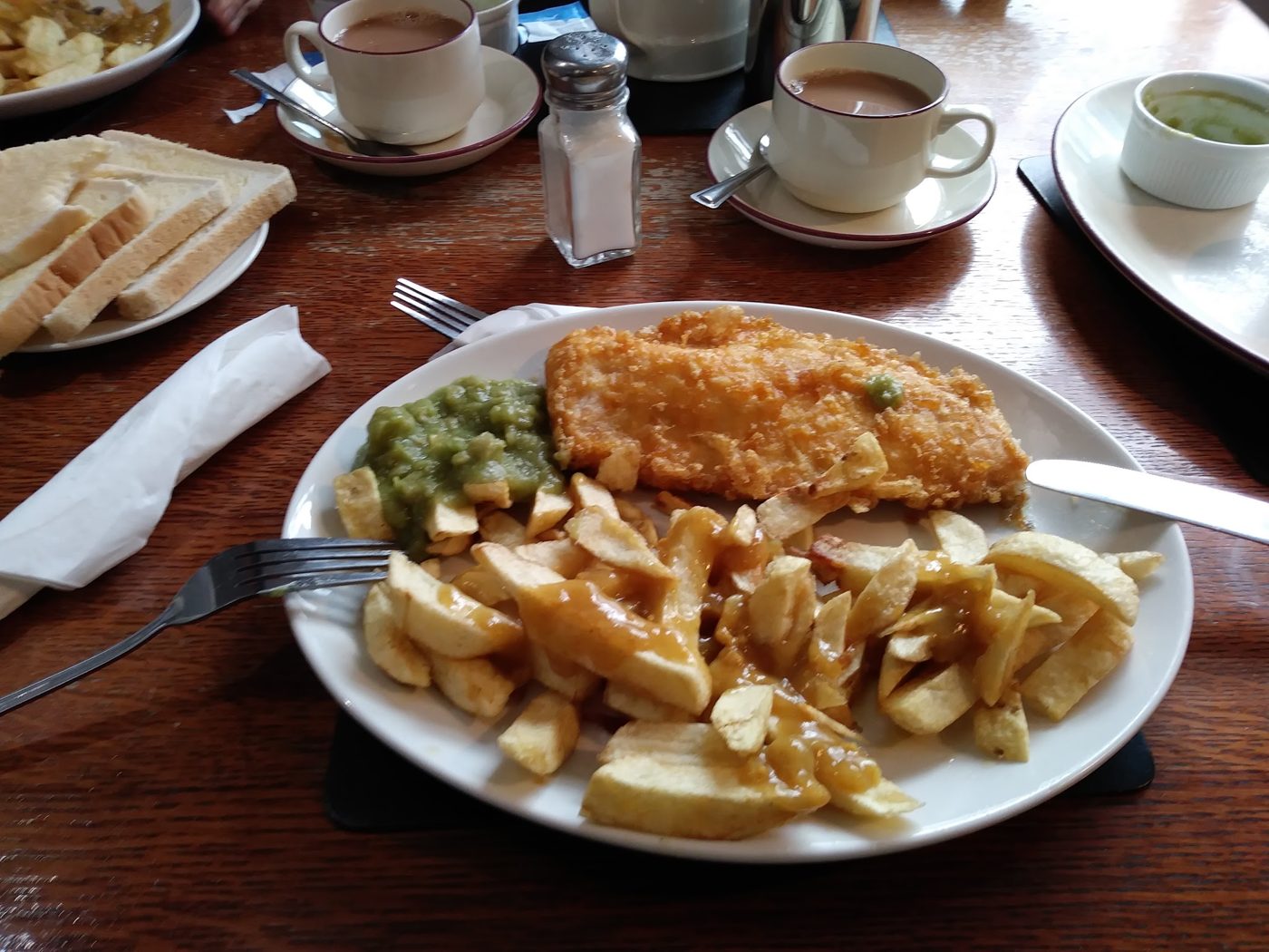 Fish and chips with peas and a cup of tea